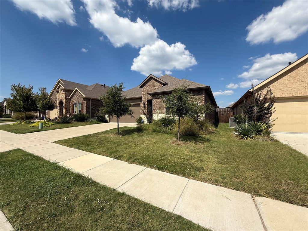 4124 Ellinger Drive Forney, TX 75126 - Photo 1 of 28 a front view of a house with a yard