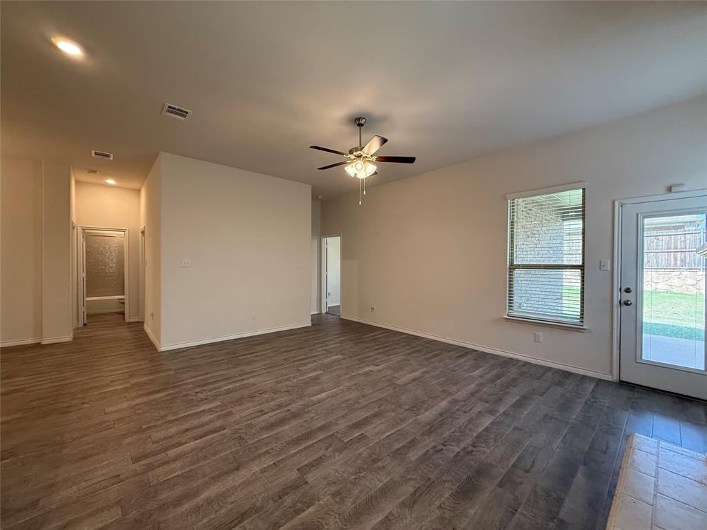 4124 Ellinger Drive Forney, TX 75126 - Photo 11 of 28 a view of an empty room with window and wooden floor
