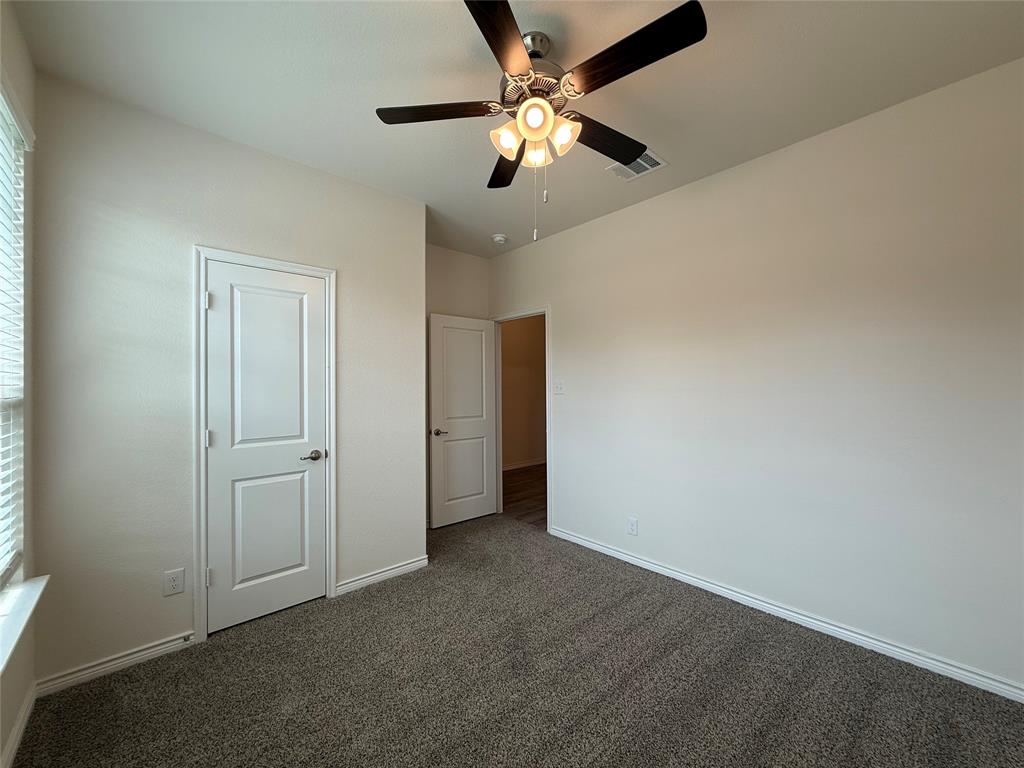 4124 Ellinger Drive Forney, TX 75126 - Photo 14 of 28 an empty room with a ceiling fan and a window