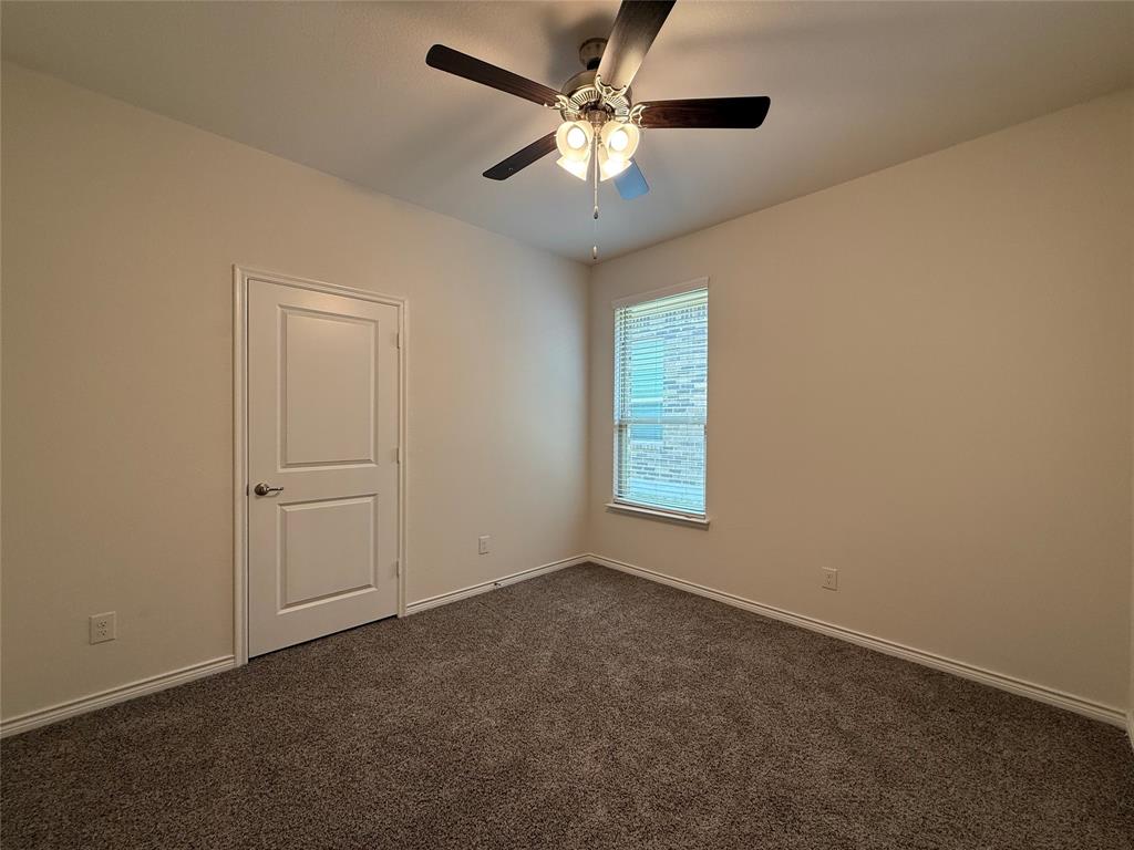 4124 Ellinger Drive Forney, TX 75126 - Photo 15 of 28 an empty room with a window and a fan