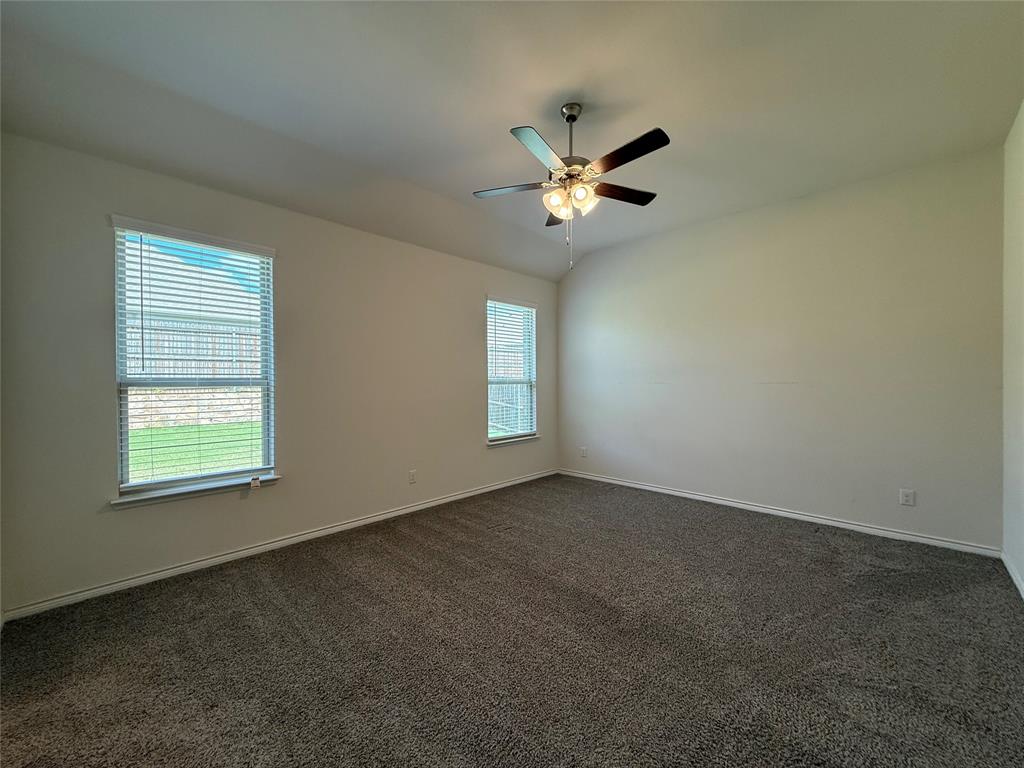 4124 Ellinger Drive Forney, TX 75126 - Photo 16 of 28 an empty room with windows and fan
