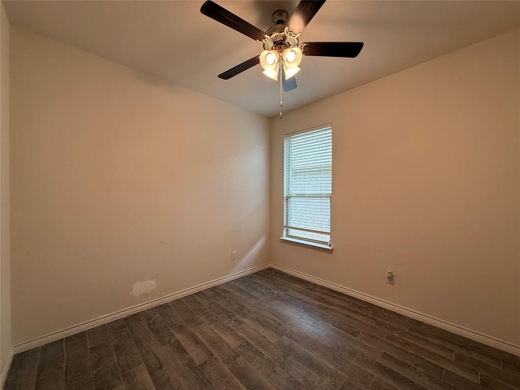4124 Ellinger Drive Forney, TX 75126 - Photo 18 of 28 an empty room with wooden floor fan and windows
