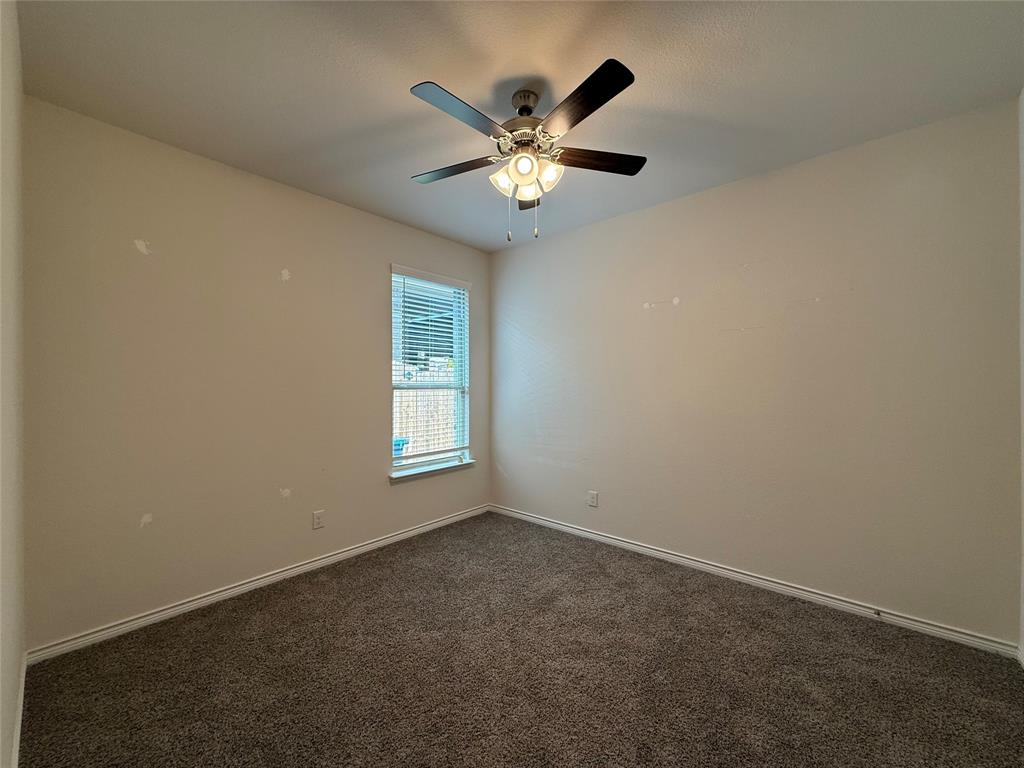 4124 Ellinger Drive Forney, TX 75126 - Photo 19 of 28 an empty room with a ceiling fan and window