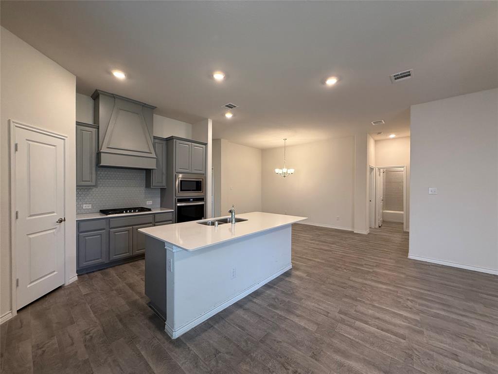 4124 Ellinger Drive Forney, TX 75126 - Photo 4 of 28 a large kitchen with stainless steel appliances a sink and a stove