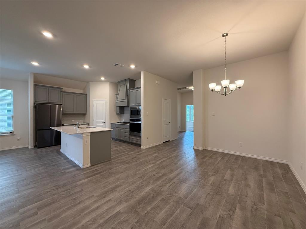 4124 Ellinger Drive Forney, TX 75126 - Photo 8 of 28 a view of kitchen with refrigerator microwave and furniture