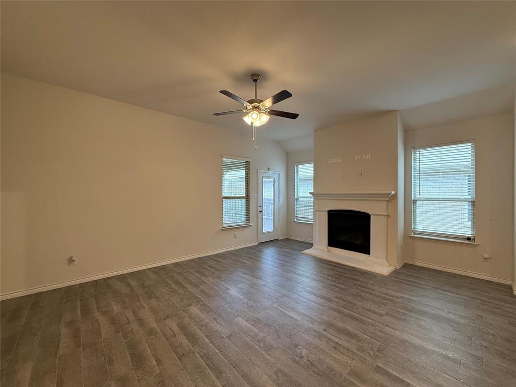 4124 Ellinger Drive Forney, TX 75126 - Photo 10 of 28 a view of an empty room with a fireplace and a window
