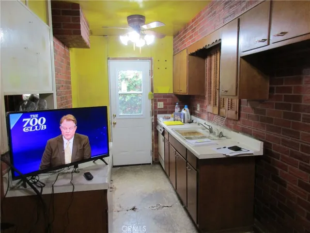 a kitchen with stainless steel appliances granite countertop a sink and a microwave