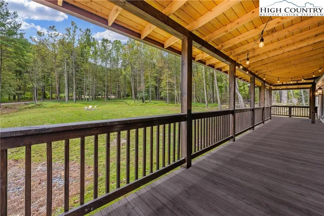 a view of a porch with wooden floor and outdoor space