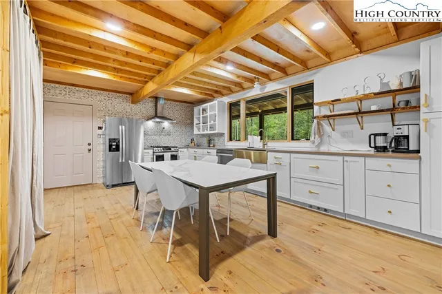a kitchen with stainless steel appliances kitchen island granite countertop a sink and cabinets