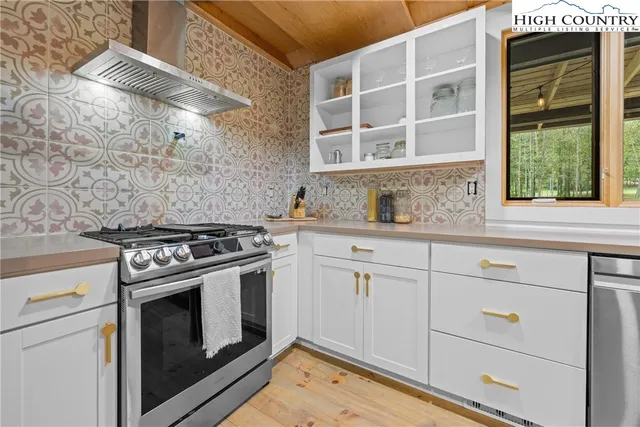 a kitchen with cabinets appliances and a window
