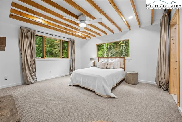 a bed room with a bed and a large window