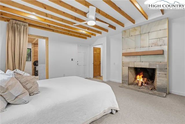 a bedroom with a bed and a fireplace