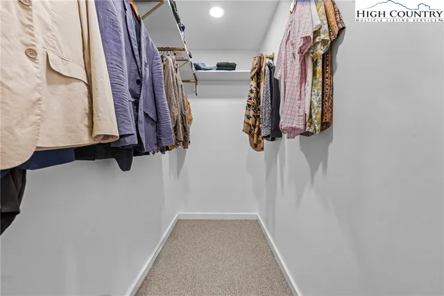 a view of walk in closet with clothes