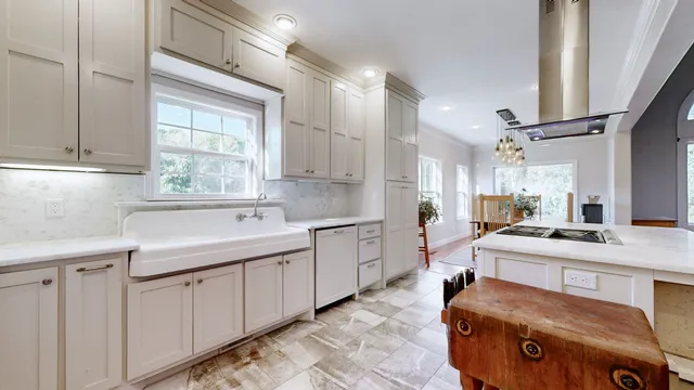 a bedroom with a large bed a flat tv screen and dresser