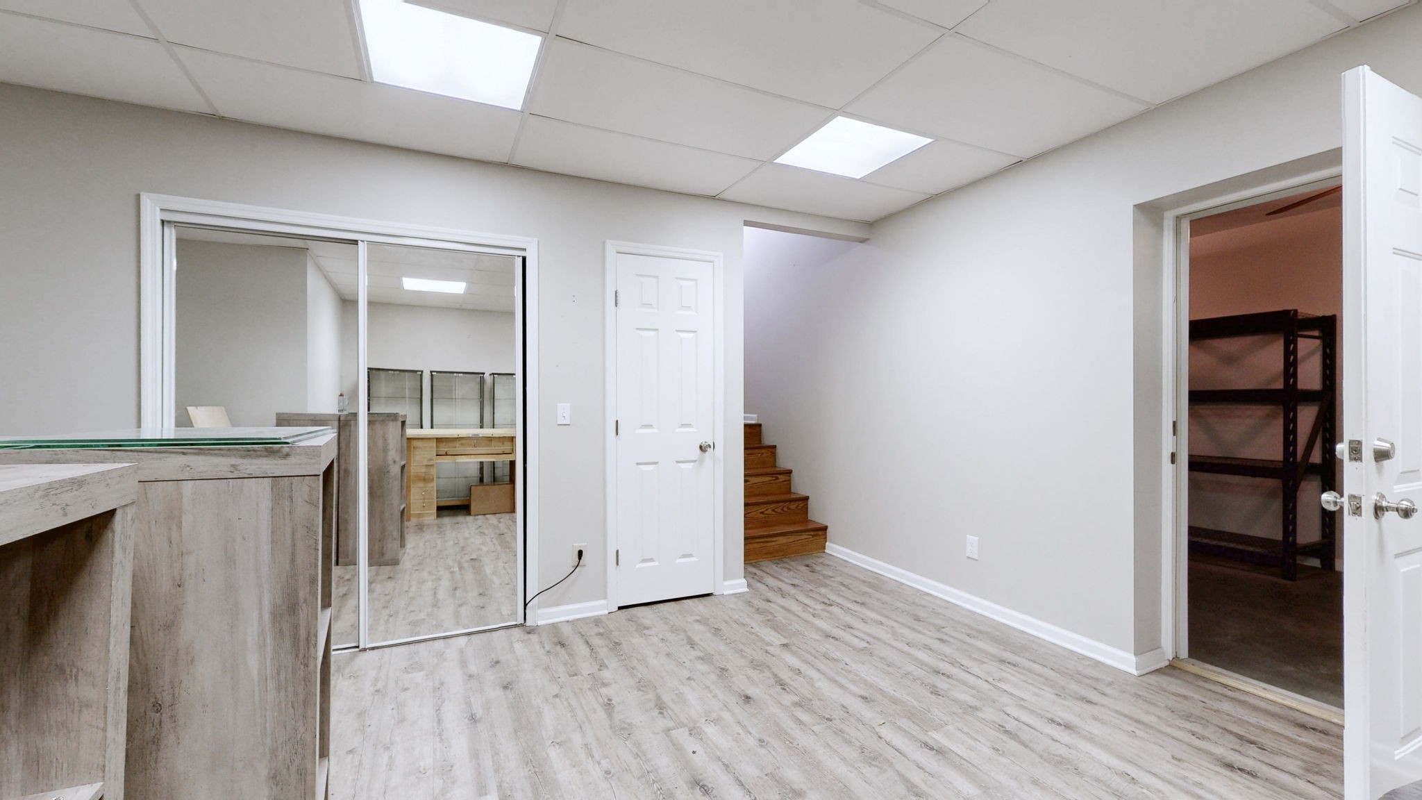 3400 Cobblestone Mills Road Spring Hill, TN 37174 - Photo 35 of 63 an empty room with wooden floor and way to kitchen