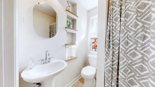 a front view of house with yard and car parked