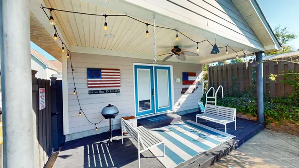a view of a house with a yard and garden