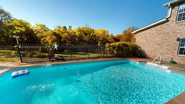 an aerial view of house with swimming pool and outdoor space