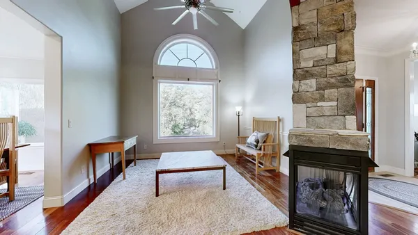 a view of a dining room with furniture and chandelier