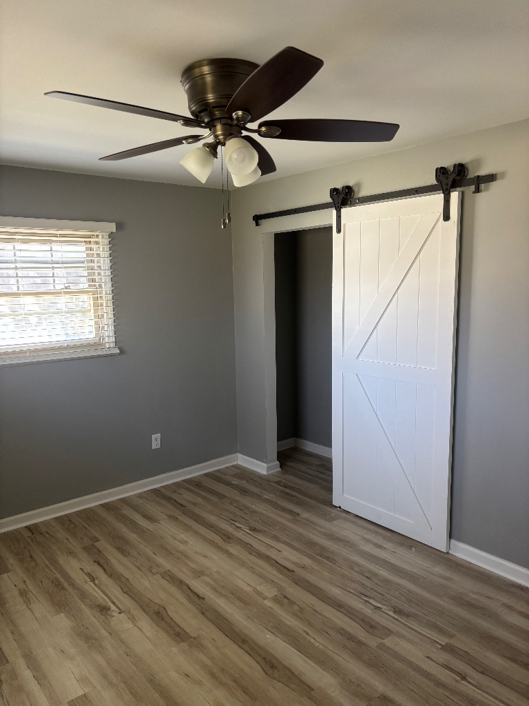 1760 Pine Bluff Road Morris, IL 60450 - Photo 10 of 10 an empty room with wooden floor fan and windows