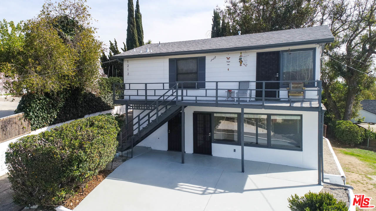 a view of a house with roof deck front of house