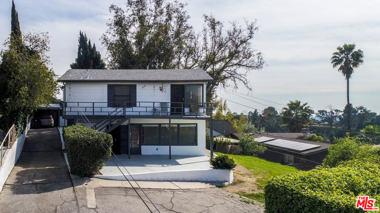 1212 Scenic Drive Glendale, CA 91205 - Photo 2 of 42 a view of a patio with couches table and chairs with wooden fence and plants