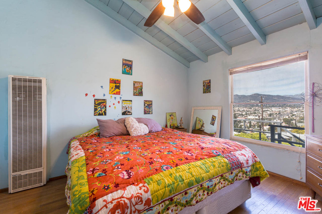 1212 Scenic Drive Glendale, CA 91205 - Photo 25 of 42 a bedroom with a bed and wooden floor