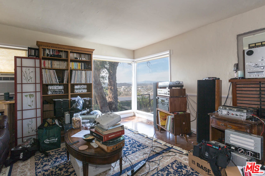 1212 Scenic Drive Glendale, CA 91205 - Photo 36 of 42 a living room with furniture a rug and a bookshelf