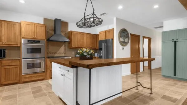 a kitchen with stainless steel appliances granite countertop a stove and a refrigerator