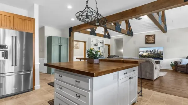 a kitchen with stainless steel appliances granite countertop a sink a refrigerator and a granite counter tops