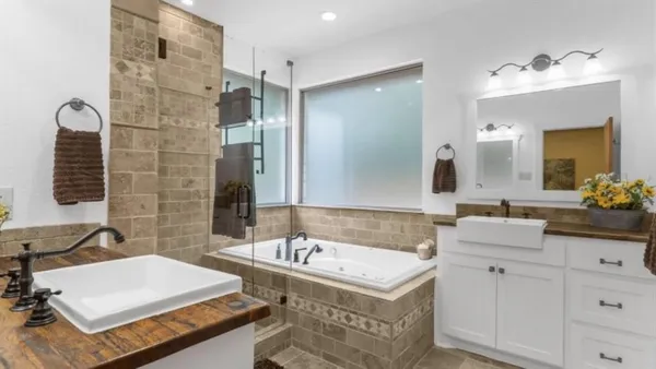 a bathroom with a sink double vanity and a mirror