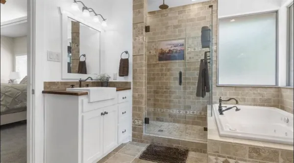 a bathroom with a bathtub sink and mirror