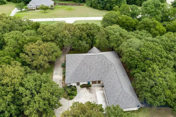 an aerial view of a house with a yard and lake view