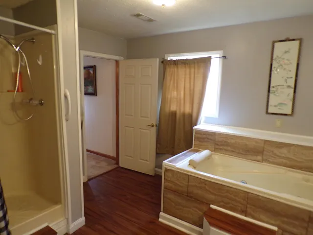 a bathroom with a tub and shower