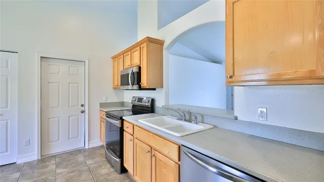 a kitchen that has a sink and a stove