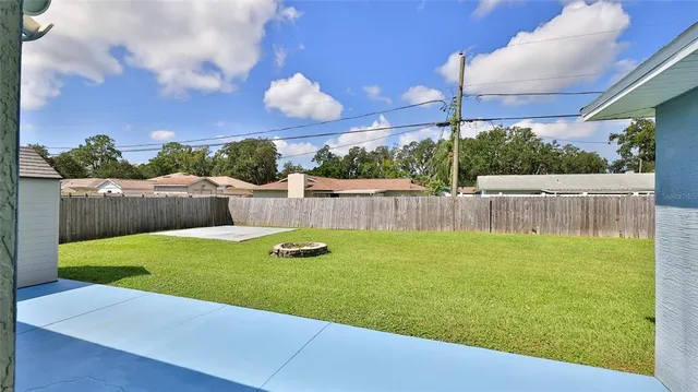 a view of yard with swimming pool and outdoor seating