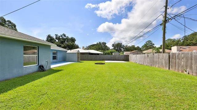 a swimming pool with outdoor seating and yard