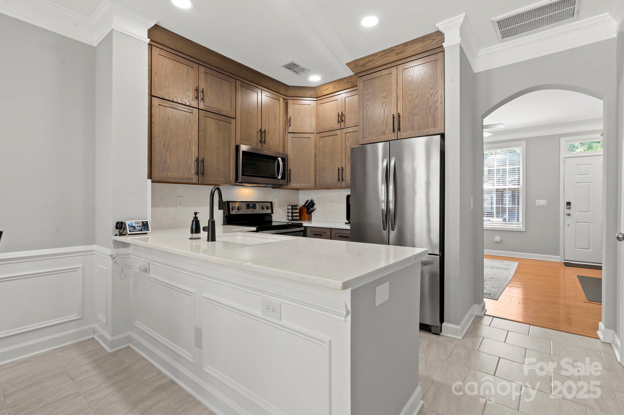 164 Singleton Road Mooresville, NC 28117 - Photo 11 of 36 a kitchen with a sink a refrigerator and a stove top oven