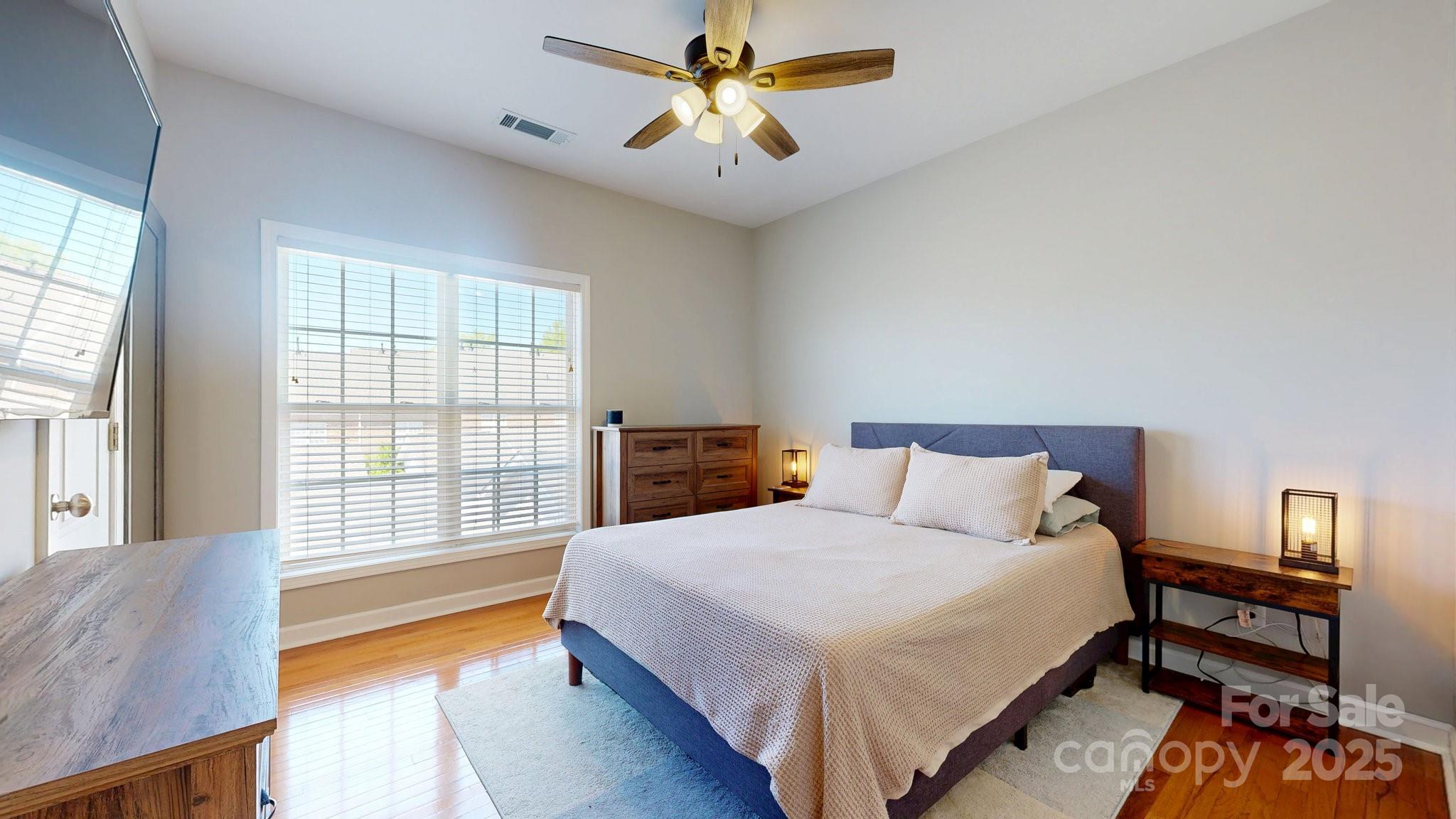 164 Singleton Road Mooresville, NC 28117 - Photo 20 of 36 a bedroom with a bed and a chandelier