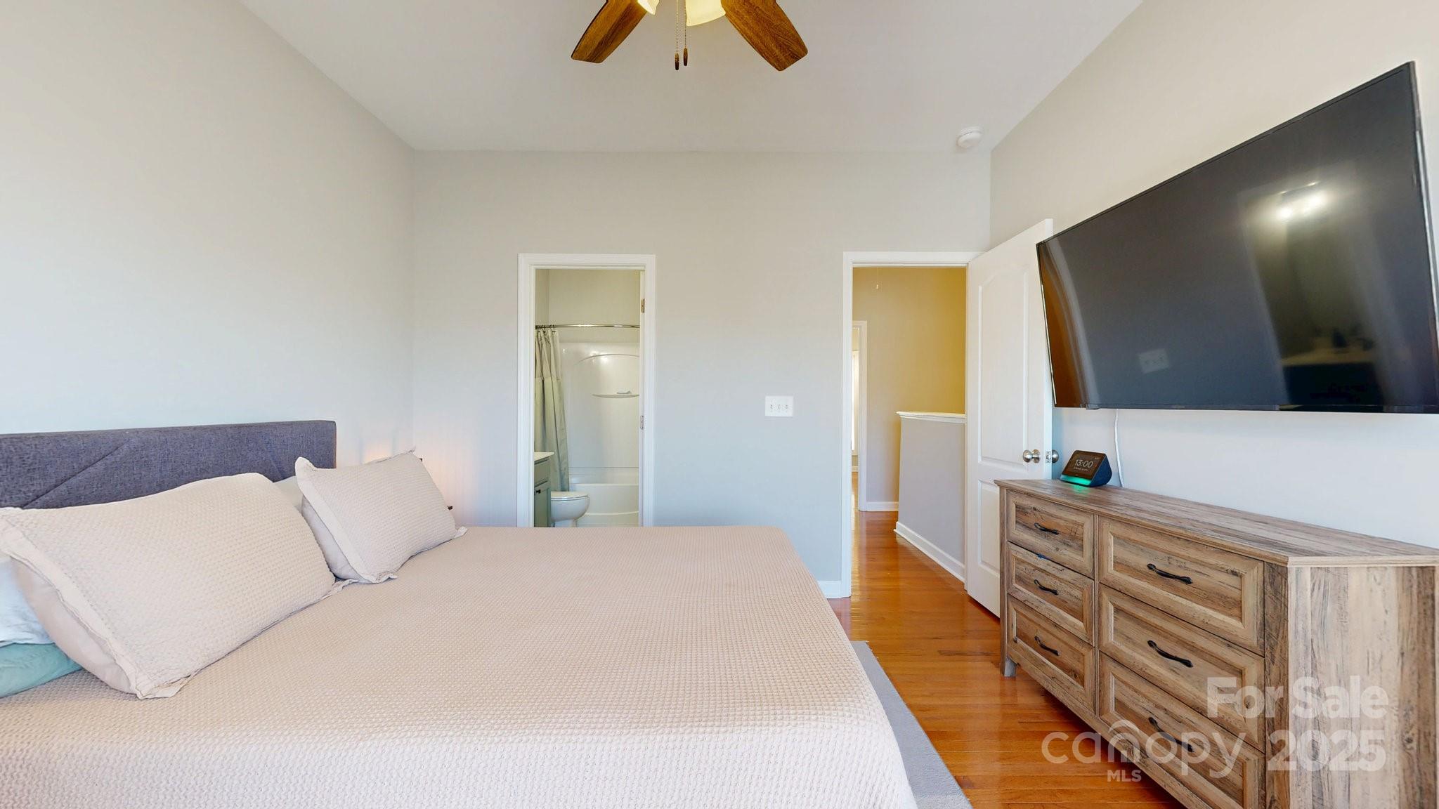 164 Singleton Road Mooresville, NC 28117 - Photo 21 of 36 a bedroom with a large bed and a flat tv screen on a dresser