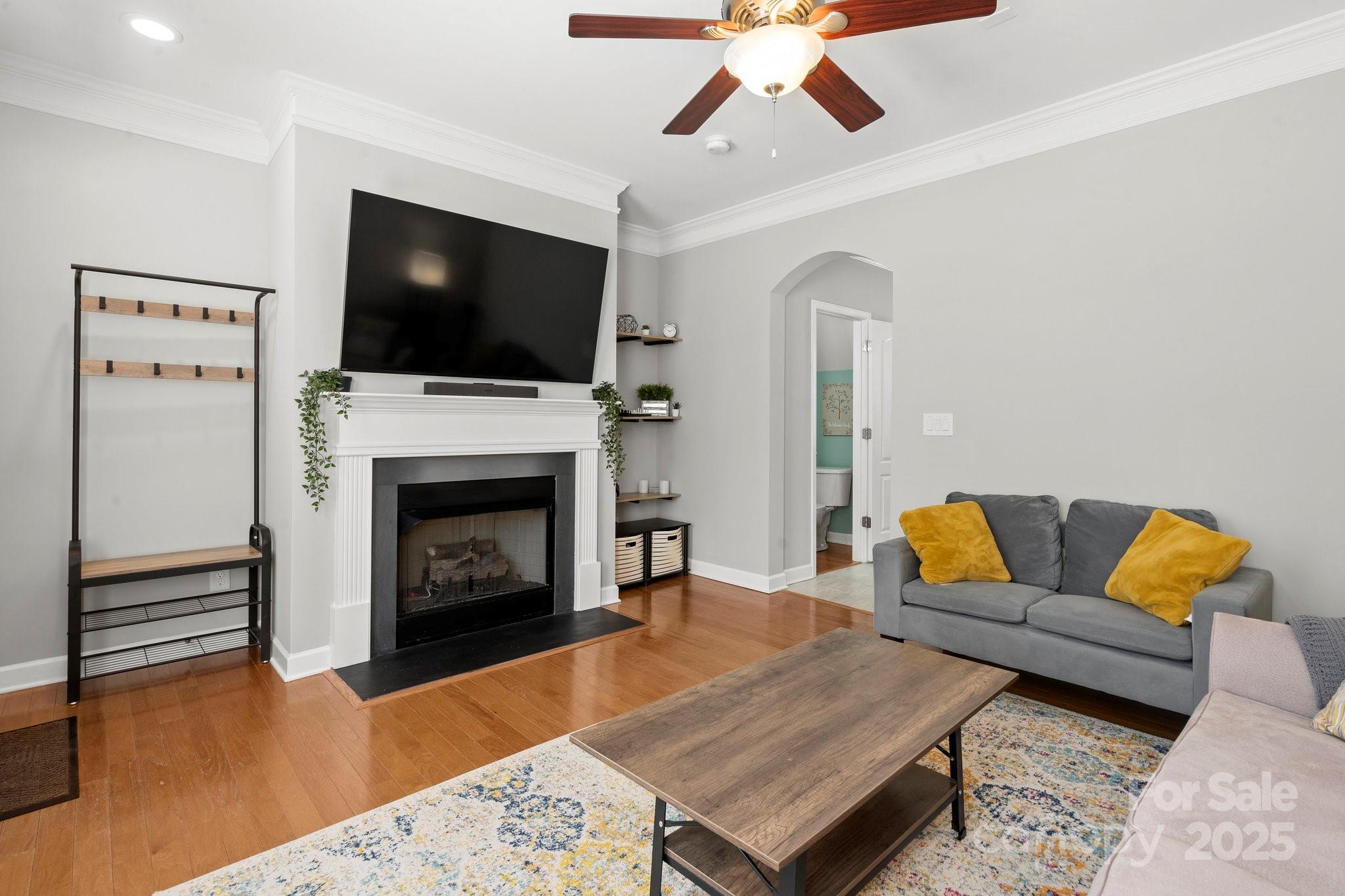 164 Singleton Road Mooresville, NC 28117 - Photo 4 of 36 a living room with furniture a flat screen tv and a fireplace