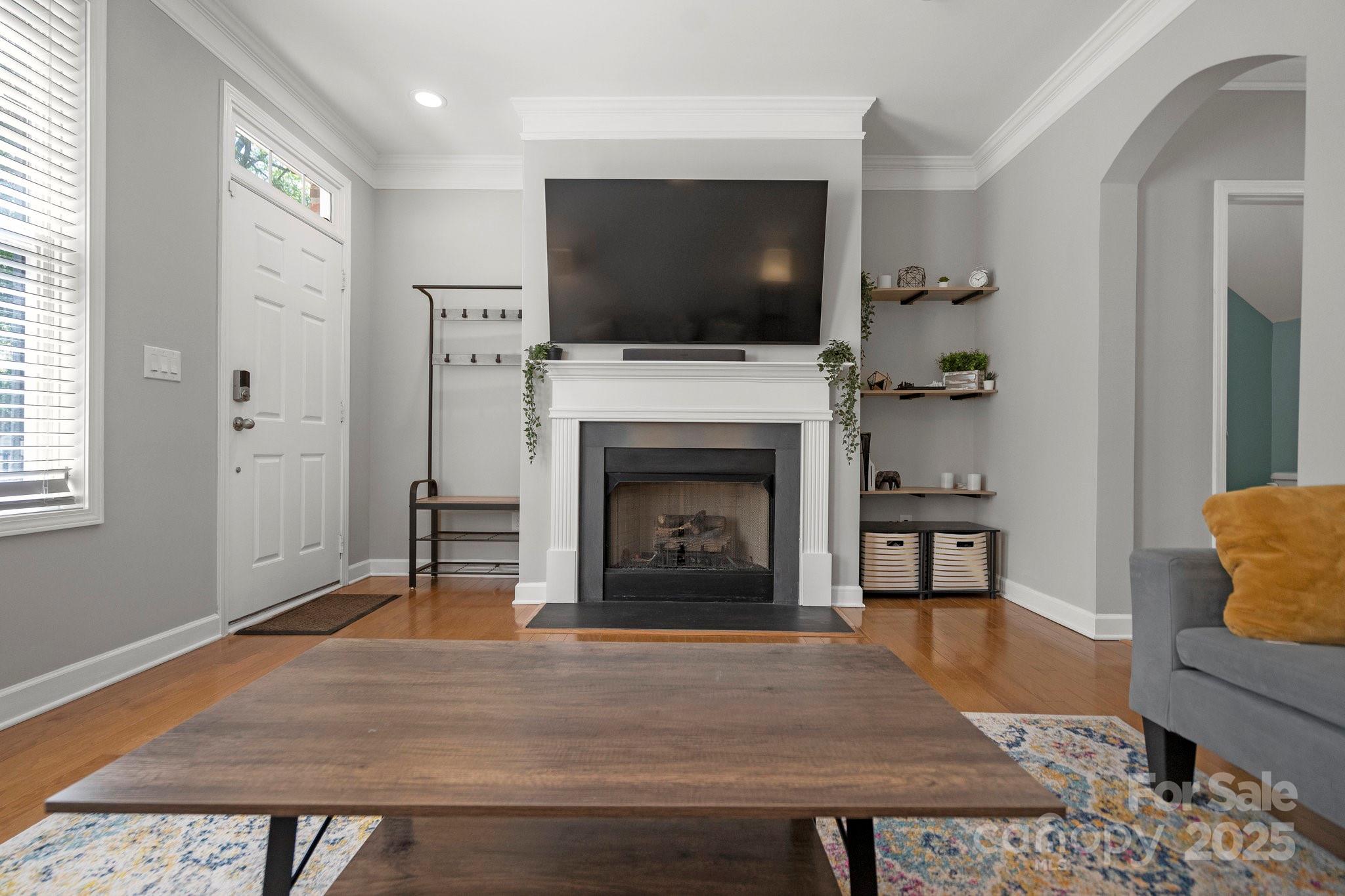 164 Singleton Road Mooresville, NC 28117 - Photo 8 of 36 a living room with furniture a flat screen tv and a fireplace