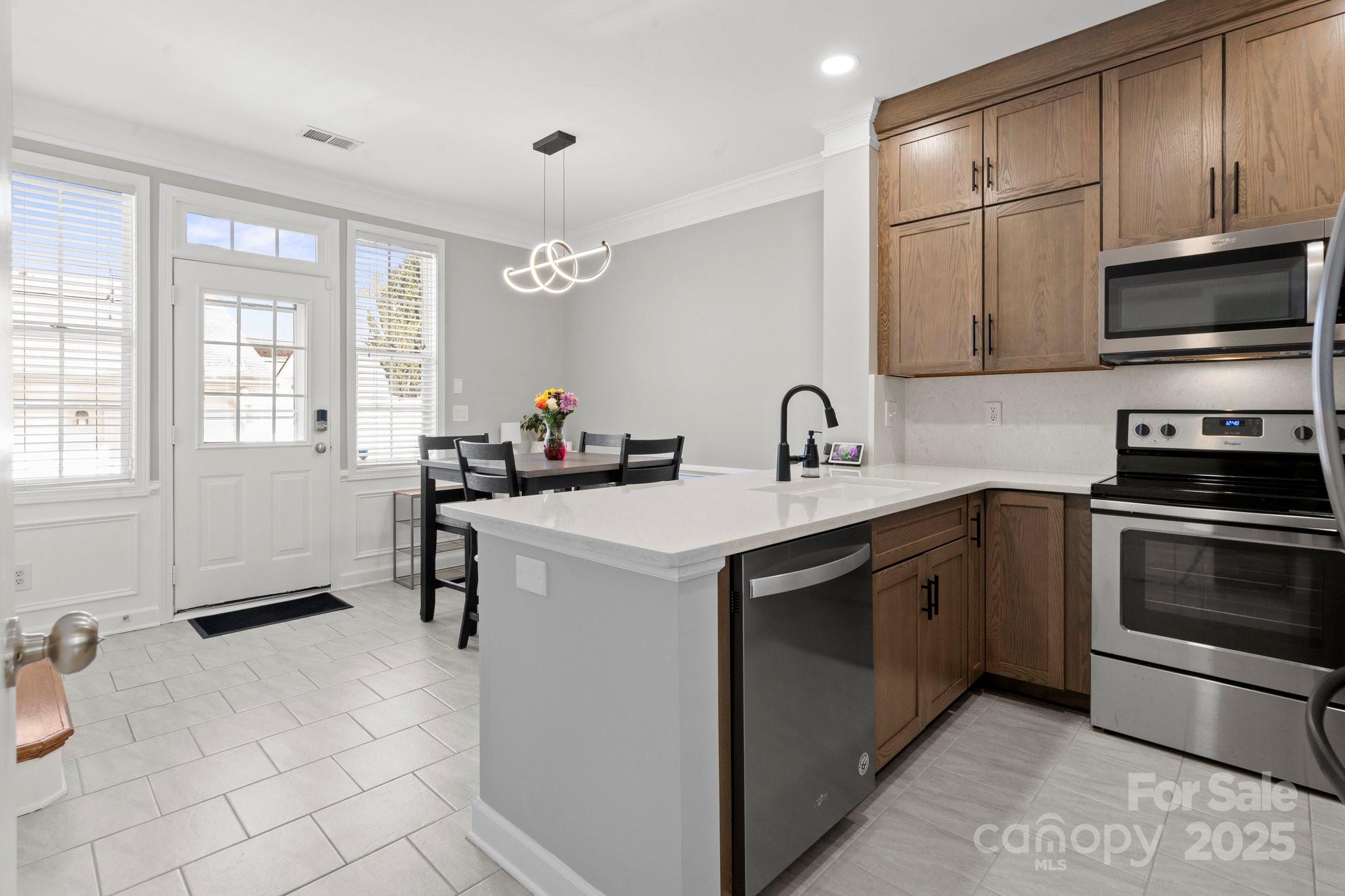 164 Singleton Road Mooresville, NC 28117 - Photo 10 of 36 a kitchen with a sink stove and microwave