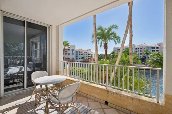 a balcony with table and chairs