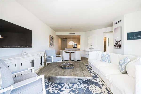 a bedroom with a bed and a flat tv screen on dresser