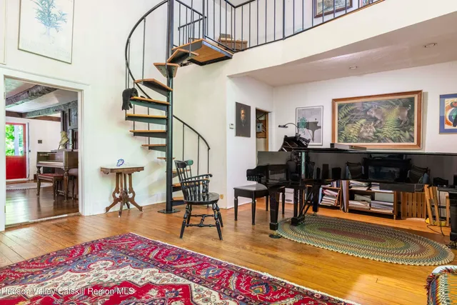 a living room with furniture a rug and entryway