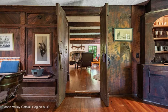 a view of a entryway door of the house and living room