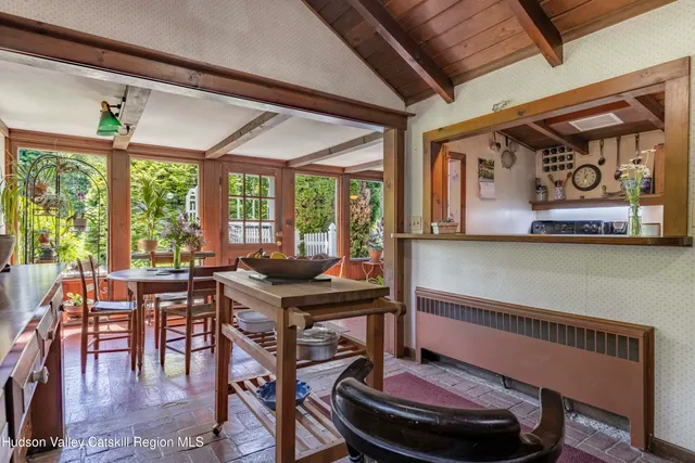 a dining room with furniture and a window