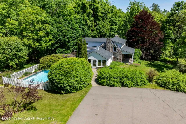 an aerial view of a house with a yard