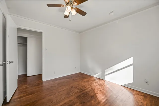 a view of empty room with wooden floor